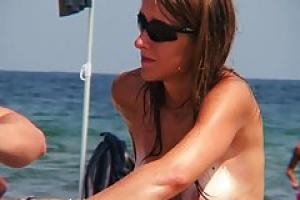 Slim teen with small tits took off her clothes on the beach  in front of everyone